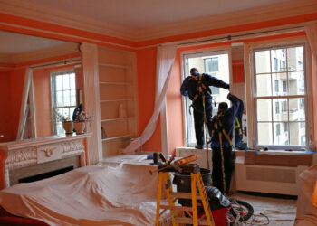 installing double glazed windows by a men