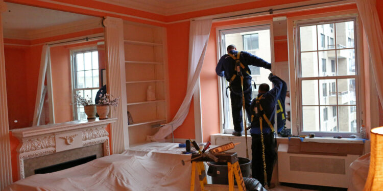 installing double glazed windows by a men