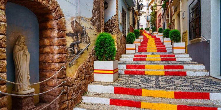 narrow alley decorated with flag spain steps calpe alicante