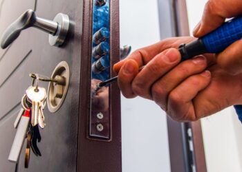 A Locksmith opening the lock of a door