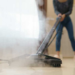 A person cleaning the floor with steam Cleaner