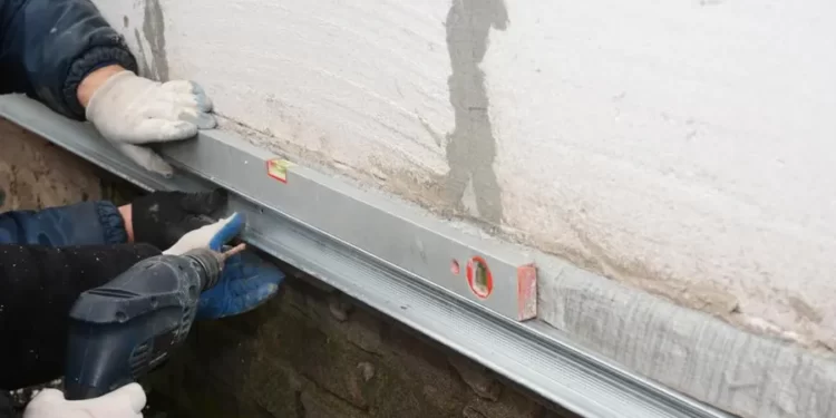 A person repairing the foundation