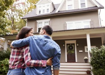 Couple Standing in front of house