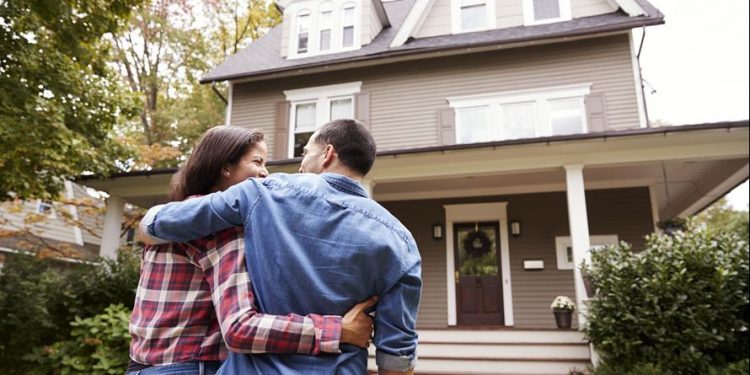 Couple Standing in front of house