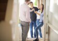 Landlord handing over keys to couple