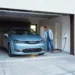 Man Using Home Charging Station to Charge Electric Car