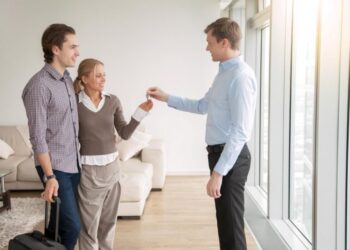 couple handing over keys to property manager