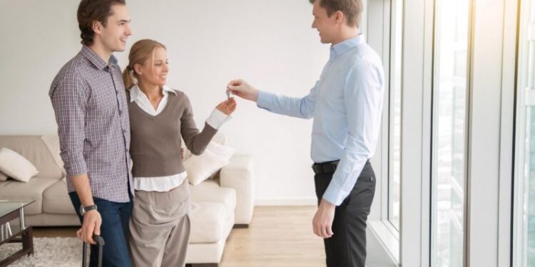 couple handing over keys to property manager