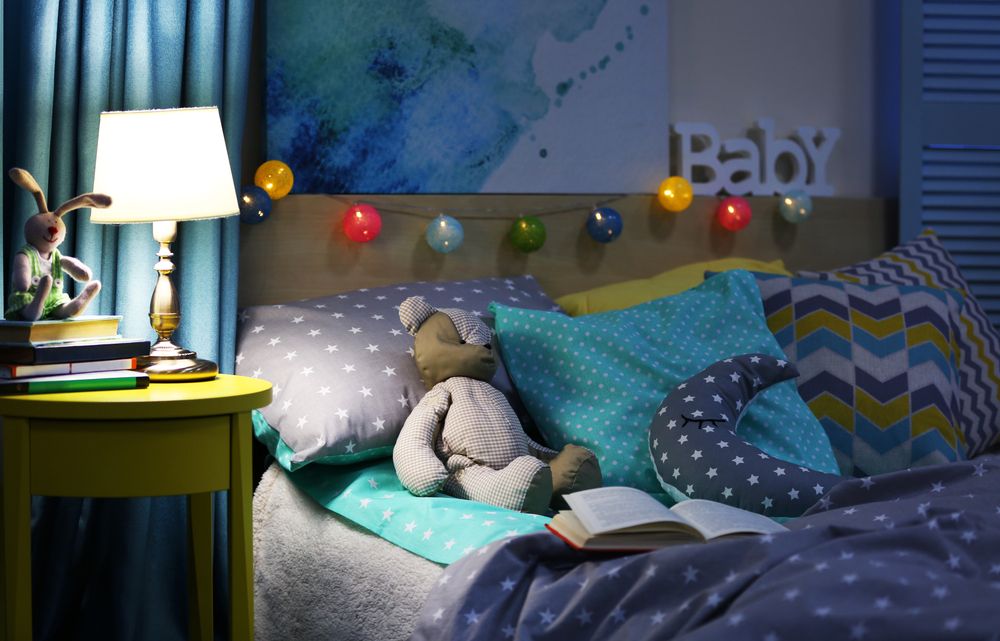 decorated bedroom with toy on the bed and light in the right
