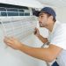 portrait of mid-adult male technician repairing air conditioner