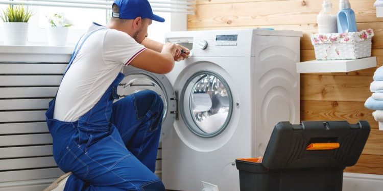guy repairing washing machine