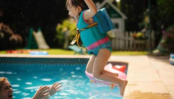 girl jumping in pool
