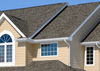 tan house gray roof with bule window