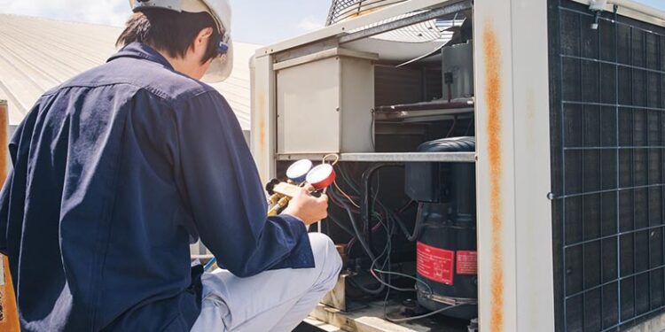 technician checking ac unit
