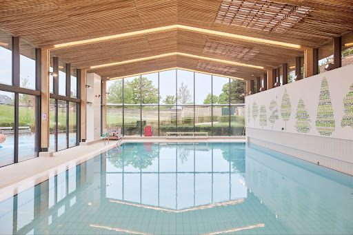 A swimming pool, enhanced by glass walls