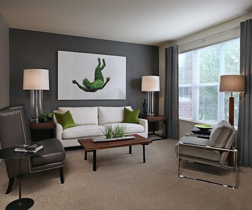 room with gray wall and sandstone carpet