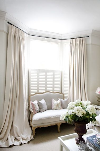 white curtain with sofa and beautiful flower 